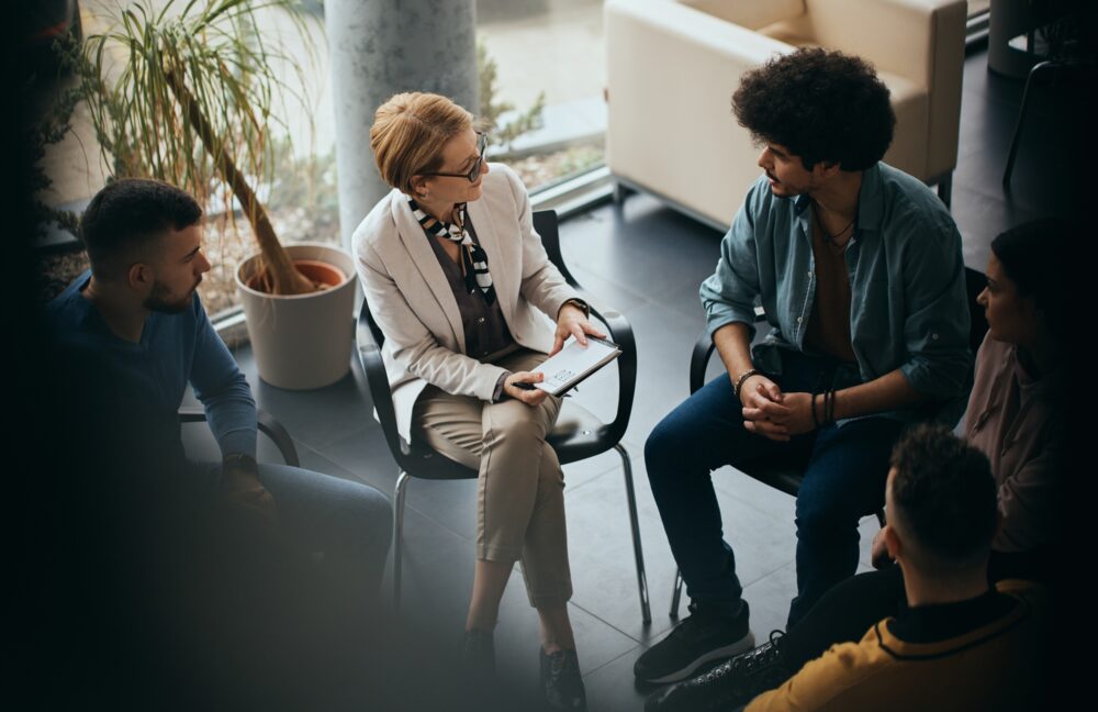 Above view of counseling during group therapy at mental health center.